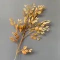 Realistic artificial banyan leaf branch with vibrant spray-painted yellow foliage - Dark Champagne