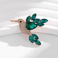 Detailed view of elegant hummingbird brooch with emerald green and white rhinestones - Green