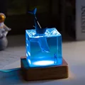 Detailed view of ocean whale resin night light with blue LED glow on wood base - Megalodon (USB Plug-in RGB Base) / 5cm