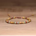 Close-up view of handmade adjustable bracelet with 2x4mm natural Picture Jasper and Red Jasper - Picture Jasper Gold Spacer Style / Gold