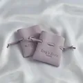 Two lavender microfiber drawstring jewelry pouches for necklaces and earrings shown on silk - 7*8cm / Light Purple