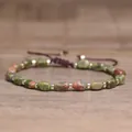 Close-up detail of natural unakite stone beads and golden spacers on handmade bracelet - Unakite