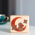 Macro view of the wooden baby keepsake box with a rabbit and moon wood-inlay design - Rabbit Moon Maple Box