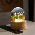 Elegant crystal ball night light featuring resin deer on a warm natural wood base. - Three Elks (Rechargeable)