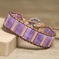 Detailed view of a purple natural stone woven wrap bracelet with gold metal bars. - Phosphosiderite