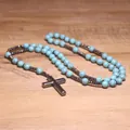 Close-up of handmade turquoise and hematite beaded rosary necklace with cross pendant - Turquoise