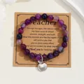 Detailed view of purple natural stone bead bracelet with silver apple charm on gift card - Purple Stripe Agate