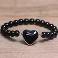 Detailed view of a black 8mm beaded bracelet with a centered black heart pendant - Black Agate