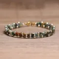Handgemaakte Tila-kralenarmband met natuursteentinten en gouden luxe tussenkralen. - Afrikaanse Pijnboomsteen