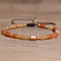 Handmade natural stone bracelet with orange barrel beads and gold-plated spacers - Red Aventurine