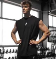 Professional fitness model in black oversized mesh sports vest for gym workouts - S / Tops / Black
