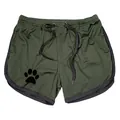 Detail of olive green mesh gym shorts with paw print design and drawstring. - M / Bottoms / Army Green with Black Trim