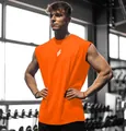Close-up of vibrant orange sleeveless gym tank top on male model in fitness center - S / Tops / Orange Red