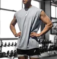 Male model wearing a light blue breathable sleeveless gym workout vest in a fitness gym - S / Tops / Light Gray