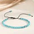 Detailed view of 4mm turquoise bead bracelet with adjustable black braided cord design - Emerald Blue