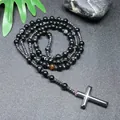 Macro view of hand-beaded black striped agate beads and hematite cross pendant - Striped Black Agate