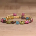 Close-up of 4mm natural tourmaline stones on a colorful woven adjustable bracelet - Rainbow Tourmaline
