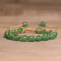 Macro view of green natural stone beads with colorful woven cord on an adjustable bracelet - Green Aventurine