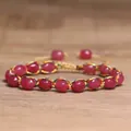 Detail view of a 4mm natural tourmaline stone woven bracelet with colorful thread - Red Tourmaline