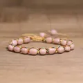 Macro detail of 4mm pink tourmaline beads woven into a colorful adjustable braided bracelet - Pink Opal