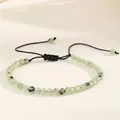 Macro detail of 4mm green natural agate beads on a black adjustable woven cord - Prehnite