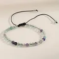 Detailed macro shot of a 4mm natural agate bead bracelet with a black adjustable cord - Green Fluorite