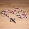Detail view of a handmade natural stone rosary necklace with a hematite cross pendant. - Rose Quartz