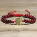 Close-up of the Tree of Life charm on a red and black woven adjustable stone bracelet - Tree of Life Style / Matte Black