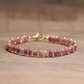 Handmade Tila bead bracelet featuring pink square tiles and gold round beads design - Red Wood Grain