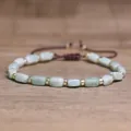 Handmade adjustable bracelet with cylindrical light green stone beads and gold spacers - Green Jade