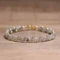 Handcrafted woven TILA bead bracelet featuring grey stone tiles and small gold accents - Labradorite