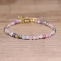 Detailed macro view of faceted multi-color natural stone beads on boho bracelet - Rainbow Tourmaline