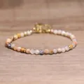 Detailed close-up of natural faceted stone beads on a handmade bohemian bracelet - Crazy Lace Agate