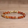 Handcrafted Tila bead bracelet featuring vibrant orange and red tones with gold accents - Red Agate