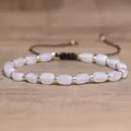 Handmade natural pink stone bead bracelet with gold accents and adjustable brown cord - White Crystal