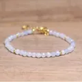 Close-up of faceted natural stone beads on a bohemian style adjustable bracelet - Aquamarine