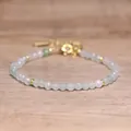 Close-up of bohemian faceted natural stone beaded bracelet with adjustable gold chain - Light Green Aventurine