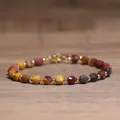 Faceted multi-colored natural stone beaded bracelet with gold spacers on wood background - Yellow Jasper / 4*6mm