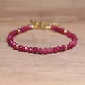 Detailed view of faceted red natural stone beads on a handmade adjustable bracelet. - Rose Red Jade