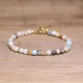 Detailed view of handmade faceted natural stone beaded bracelet with bohemian style charm - Amazonite