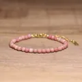 Faceted pink natural stone beaded bracelet with adjustable gold-tone chain extension - Red Wood Grain