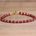 Handmade bracelet featuring faceted red natural stone beads and gold-tone spacers - Optimized Ruby / 4*6mm