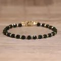 Handmade dark green faceted natural stone beaded bracelet with gold-colored round spacers - Green Goldstone / 4*6mm