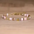 Close-up of Tila bead bracelet with gold and pink natural stone geometric beads. - Gold and Pink Color-Blocked Geometric Style