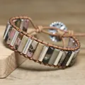 Detailed close-up of natural stone beads on a handmade bohemian wrap bracelet - Red with Black Lines