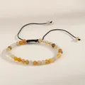Detailed view of 4mm natural stone beaded bracelet with adjustable black woven cord - Yellow Goldstone