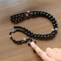 Handcrafted black lava stone rosary necklace with silver cross and religious medal - Lava Stone