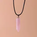 Macro detail of the hexagonal rose quartz crystal pendant hanging on a black cord - Rose Quartz