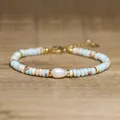 Detailed view of a handmade bracelet featuring a baroque pearl and blue natural stone beads - Light Blue
