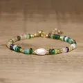 Detailed close-up view of handmade beaded bracelet with baroque pearl and colorful stones - Verdant